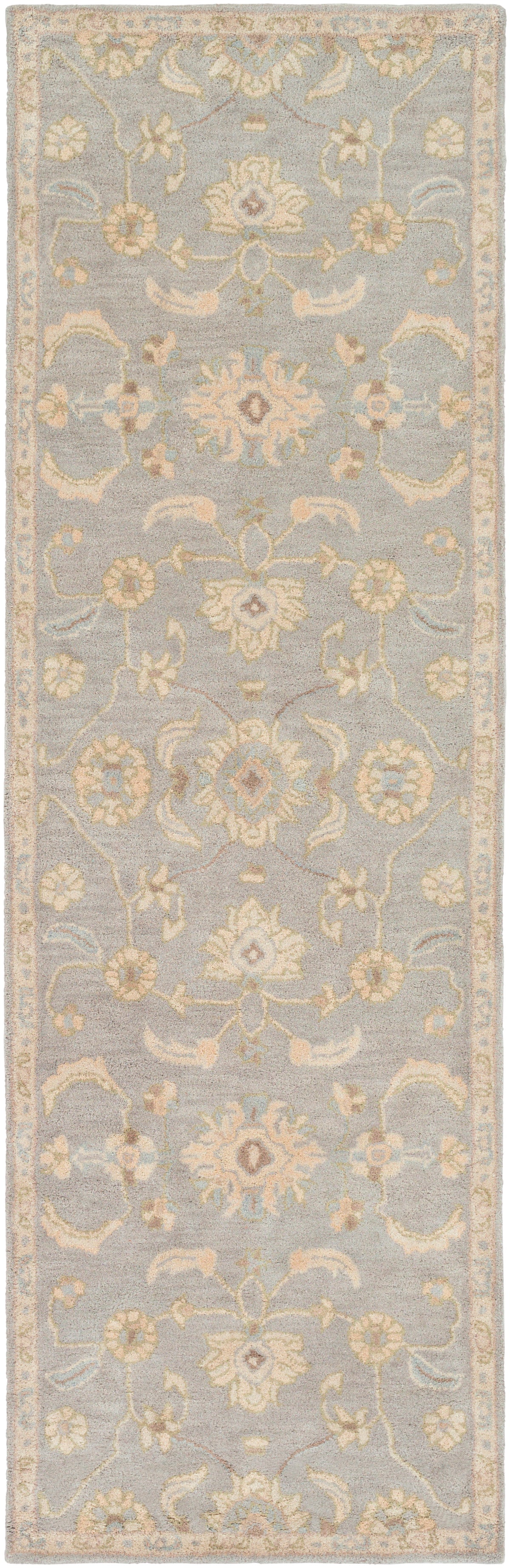 Julian Arctic hand-tufted wool runner rug with light blue background and beige floral patterns.