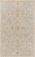 Julian Arctic hand-tufted wool rug featuring a light blue background with beige floral patterns.