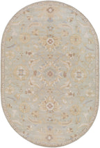 Oval Julian Arctic hand-tufted wool rug with a light blue and beige floral pattern.