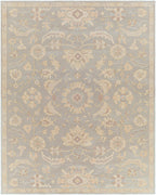 Julian Arctic hand-tufted wool rug featuring a muted blue and beige floral pattern.