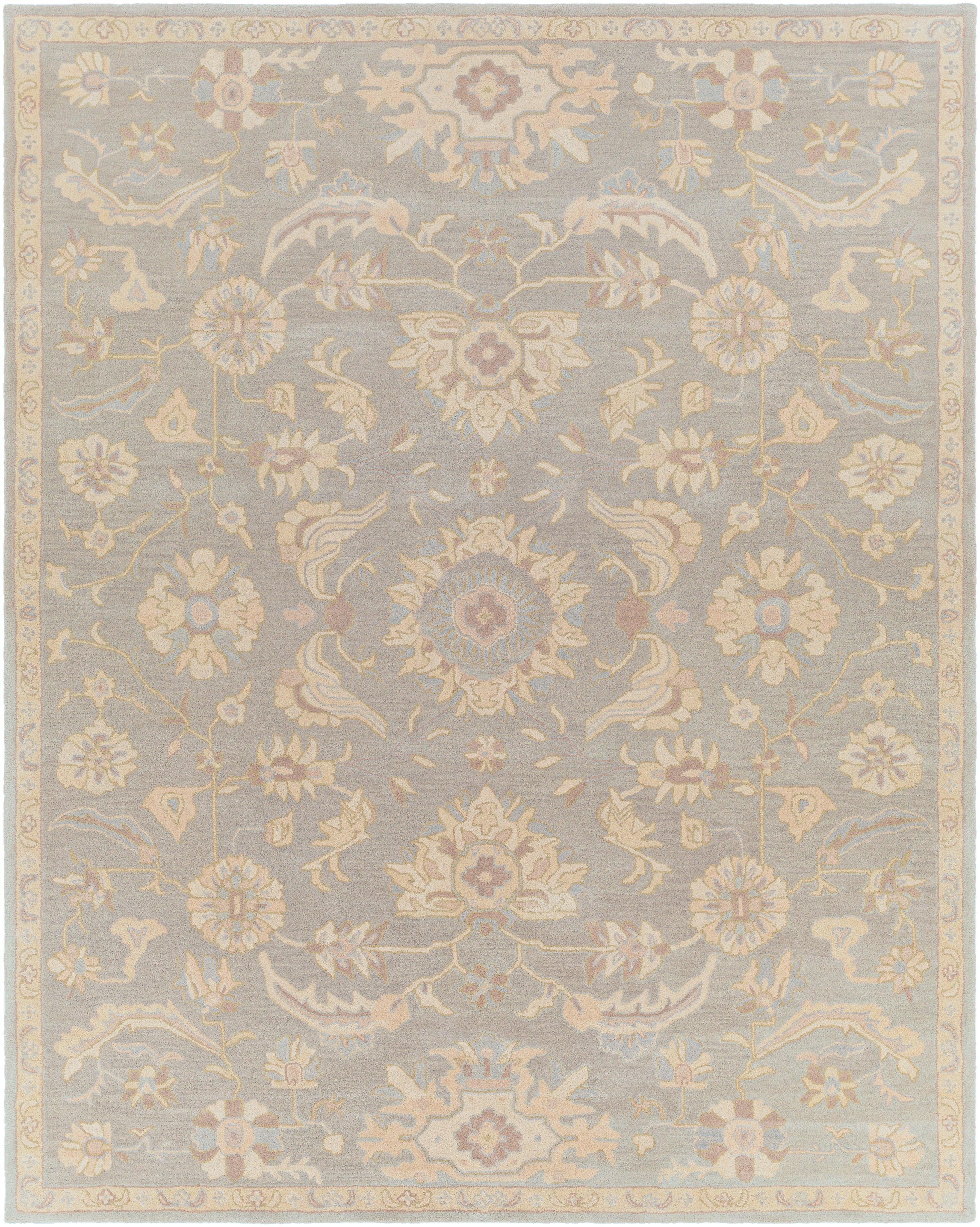 Julian Arctic hand-tufted wool rug featuring a muted blue and beige floral pattern.