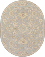 Oval Julian Arctic hand-tufted wool rug with light blue and beige floral patterns.