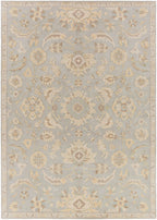 Julian Arctic hand-tufted wool rug featuring a light blue field with beige floral patterns.