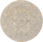 Julian Arctic round wool rug with blue and beige floral patterns