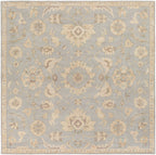 Julian Arctic hand-tufted square wool rug with a light blue and beige floral pattern.