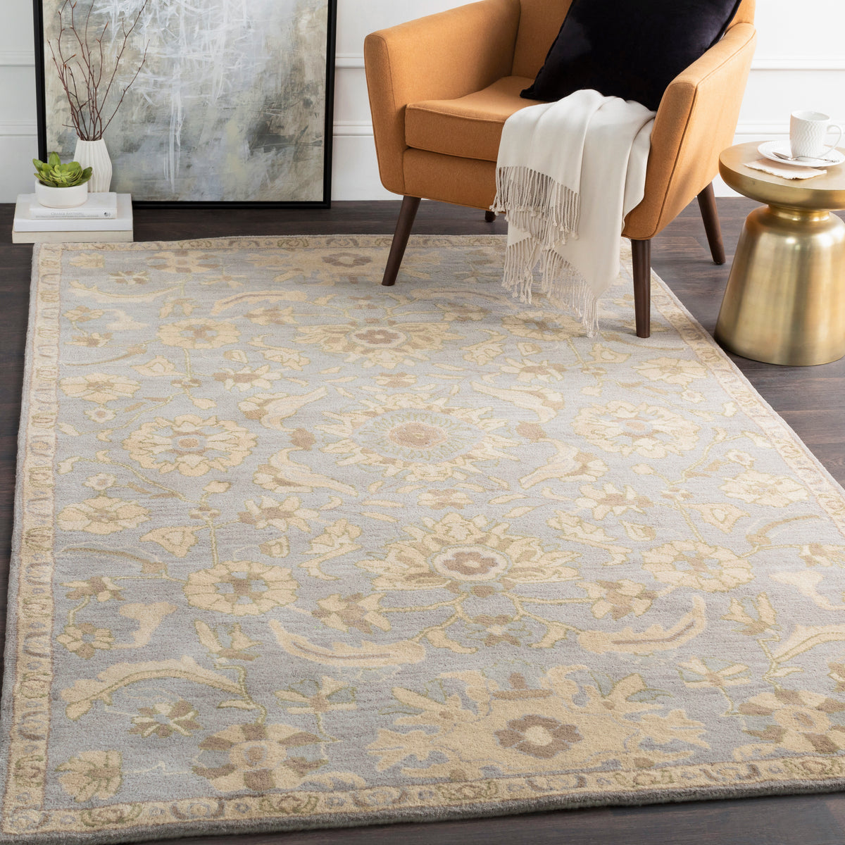 Julian Arctic hand-tufted wool rug with a blue and beige floral pattern in a living room.