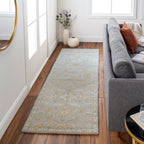 Julian Arctic hand-tufted wool runner rug with a light blue and beige floral pattern in a hallway.