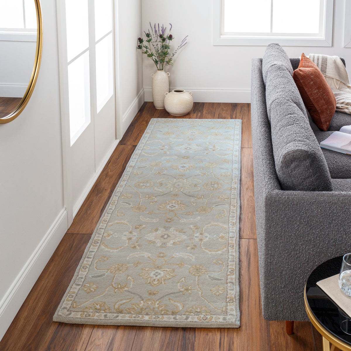 Julian Arctic hand-tufted wool runner rug with a light blue and beige floral pattern in a hallway.