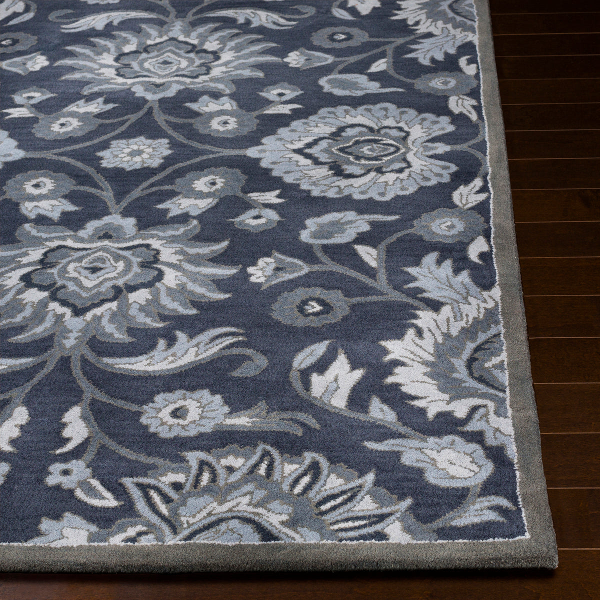 Mediterranean Ocean hand-tufted wool rug with charcoal, slate, and denim floral patterns.