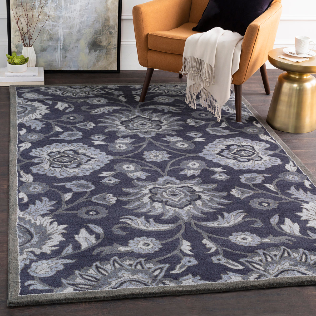 Mediterranean Ocean hand-tufted wool rug with charcoal and denim floral patterns in a living room.