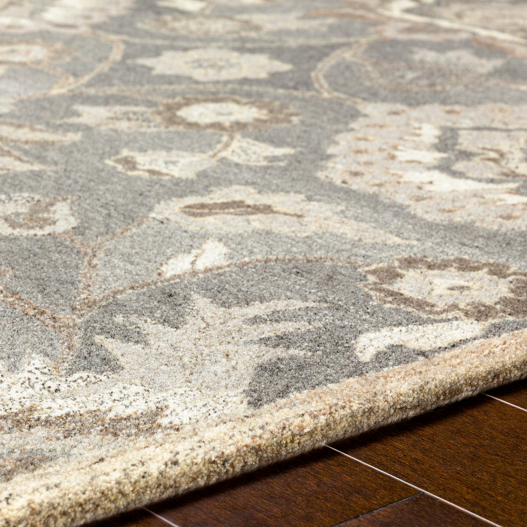 Close-up of the Mediterranean Seal hand-tufted wool rug, showing its grey and ivory floral pattern.