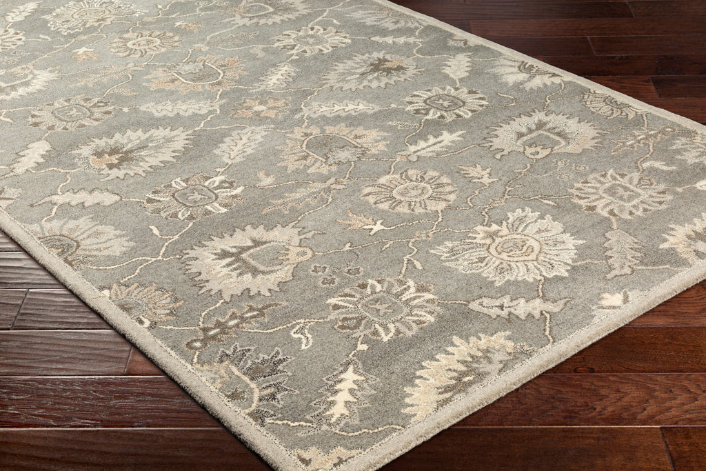 Rubicon Oyster hand-tufted wool rug with beige and grey floral patterns on dark wood floor.