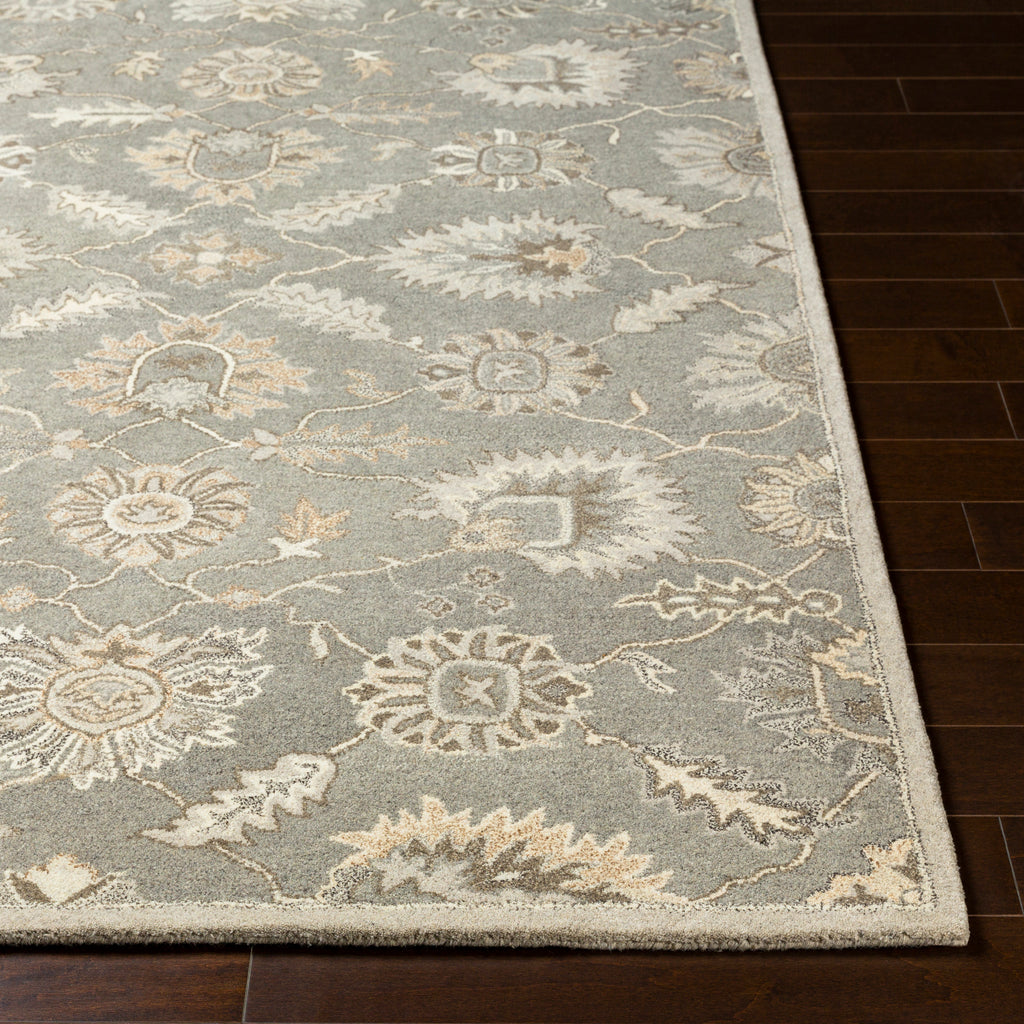 Rubicon Oyster hand-tufted wool rug with grey, beige, and ivory floral patterns on dark wood floor.