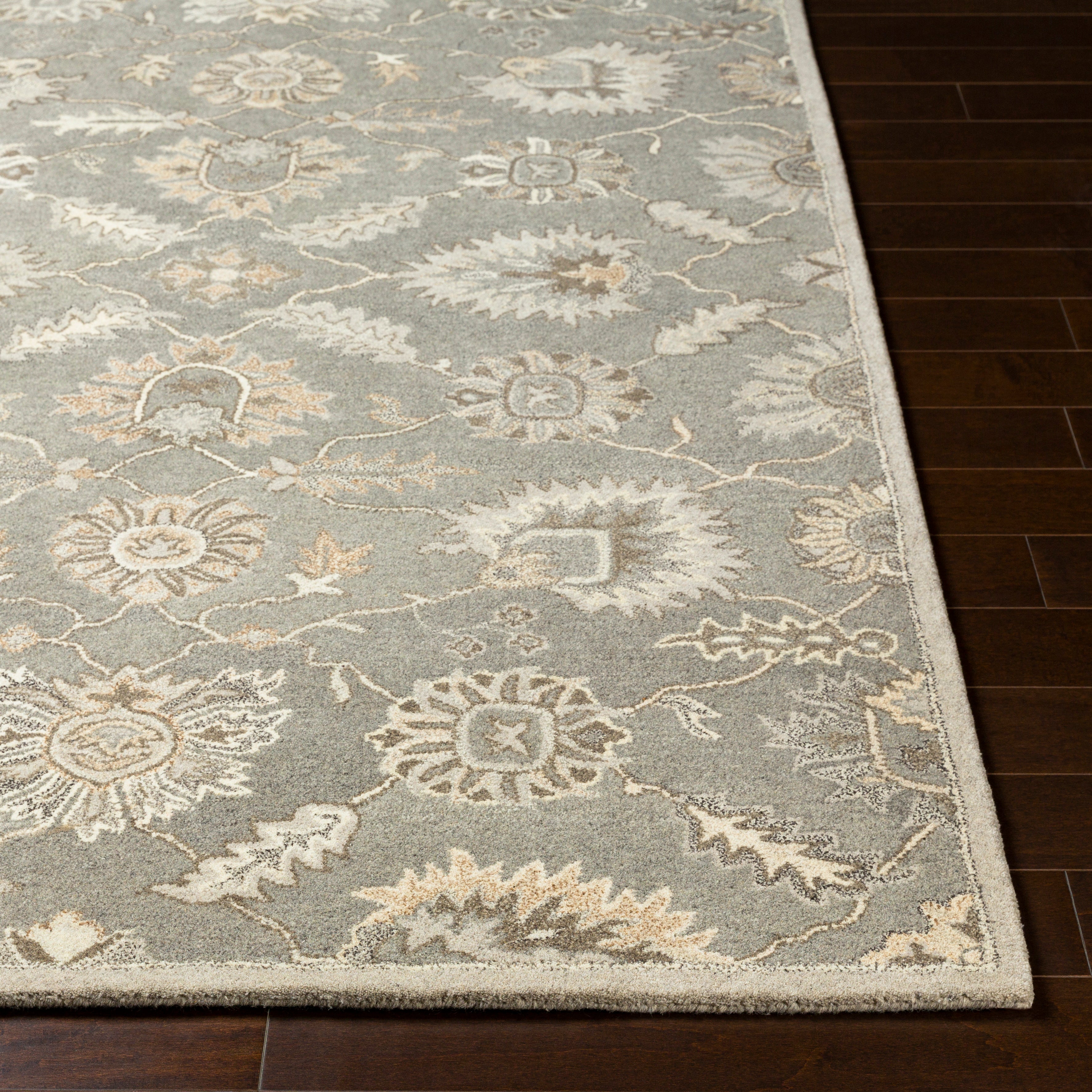 Rubicon Oyster hand-tufted wool rug with grey, beige, and ivory floral patterns on dark wood floor.