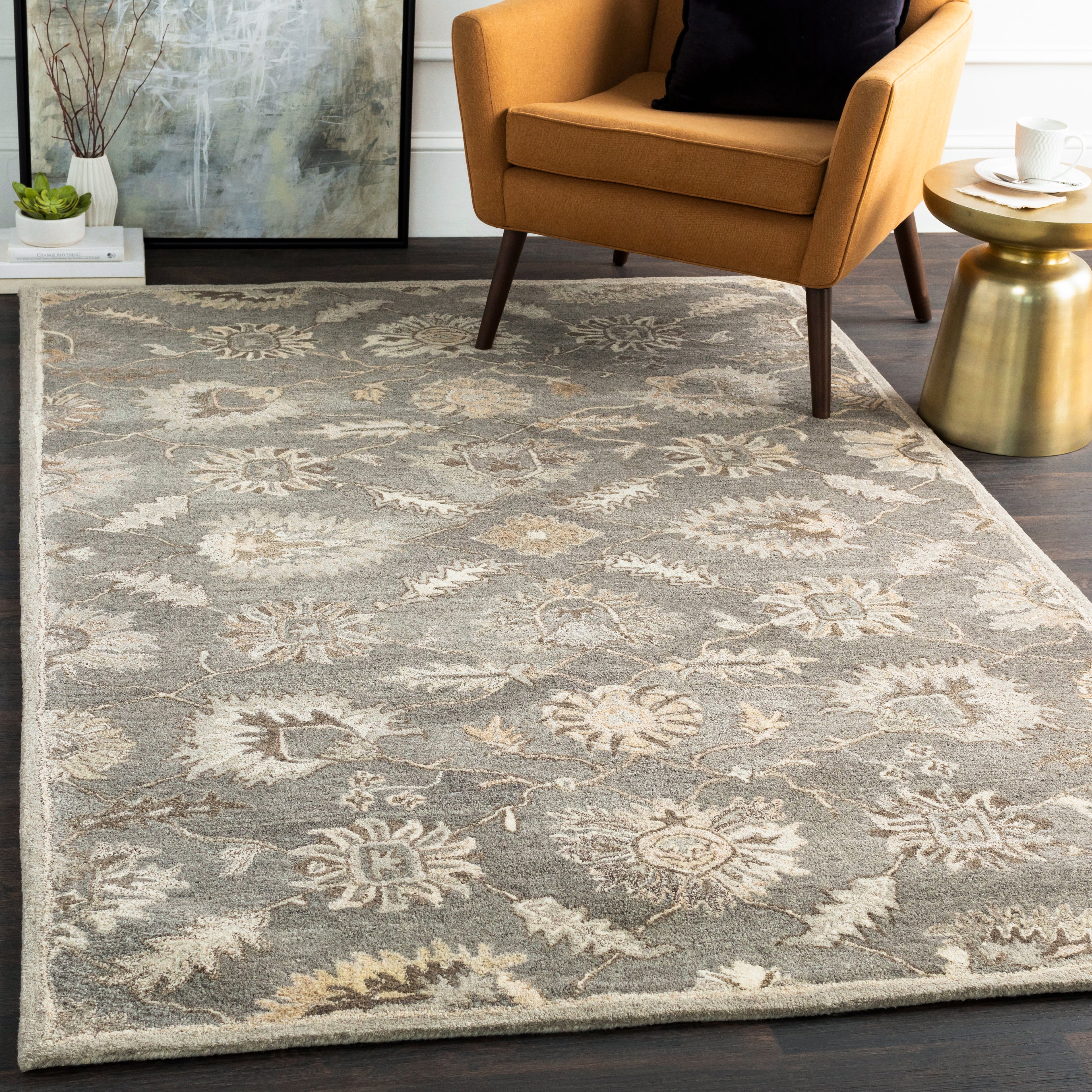 Rubicon Oyster hand-tufted wool rug with a grey and beige floral pattern under a yellow armchair