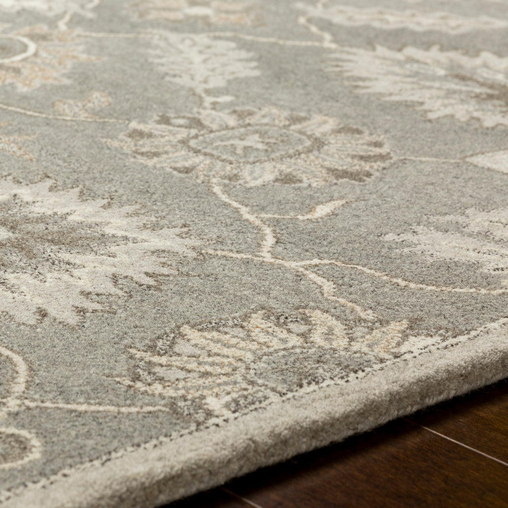 Rubicon Oyster hand-tufted wool rug with grey and ivory floral patterns on hardwood floor