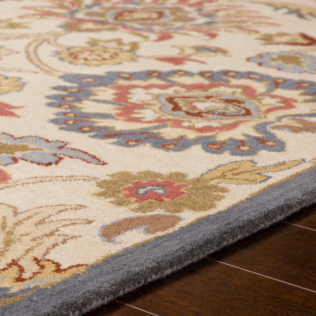 Mediterranean Fiesta hand-tufted wool rug with a colorful floral pattern and grey border.