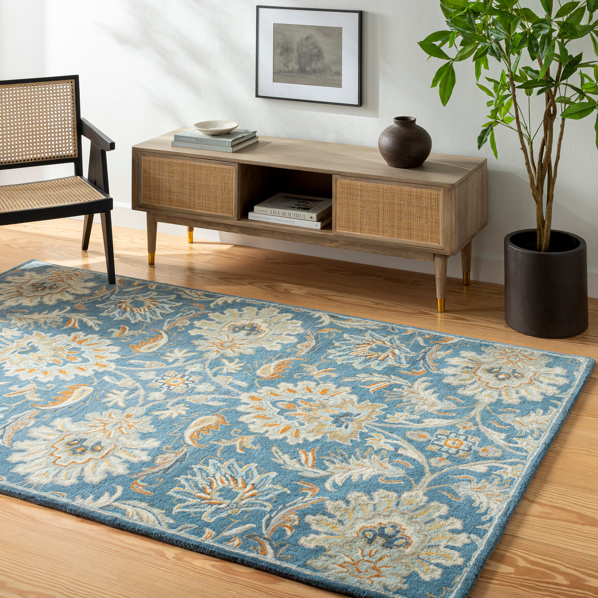 Blue Mediterranean Aegean hand-tufted wool rug with a floral pattern in a living room.