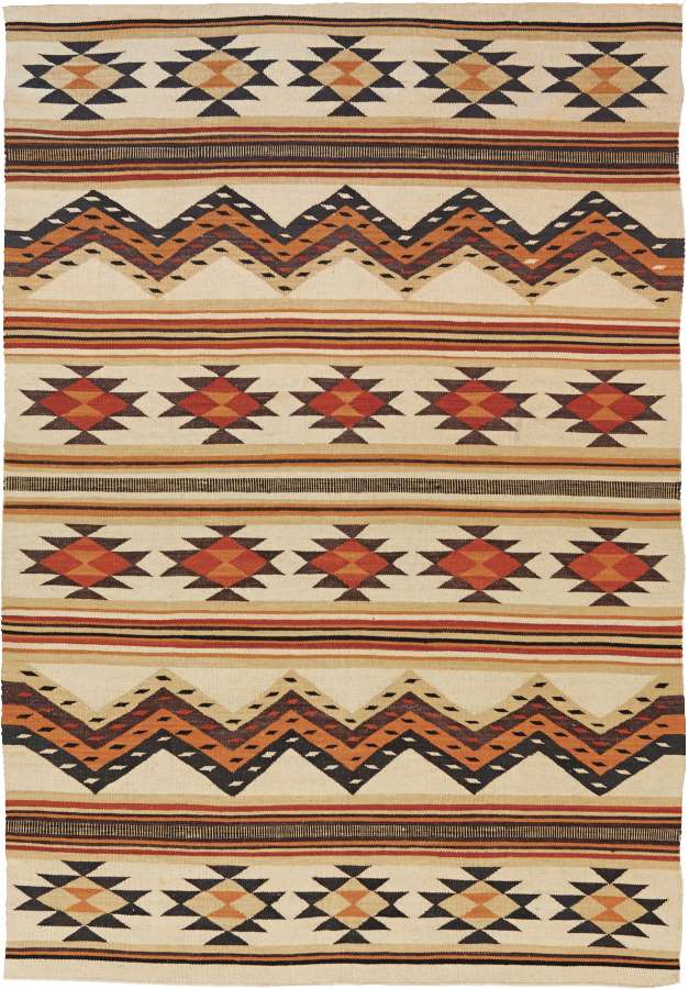 Wide Ruins Southwest flat-weave wool rug with geometric Navajo patterns in cream, orange, and brown.