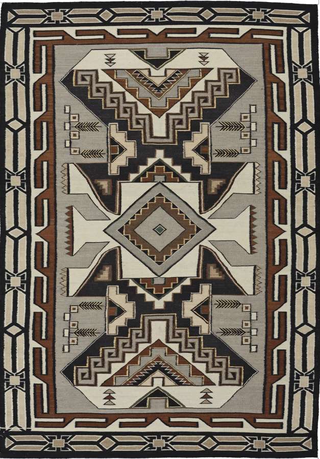 Teec Nos Pos wool flat-weave rug with Navajo geometric patterns in earth tones.