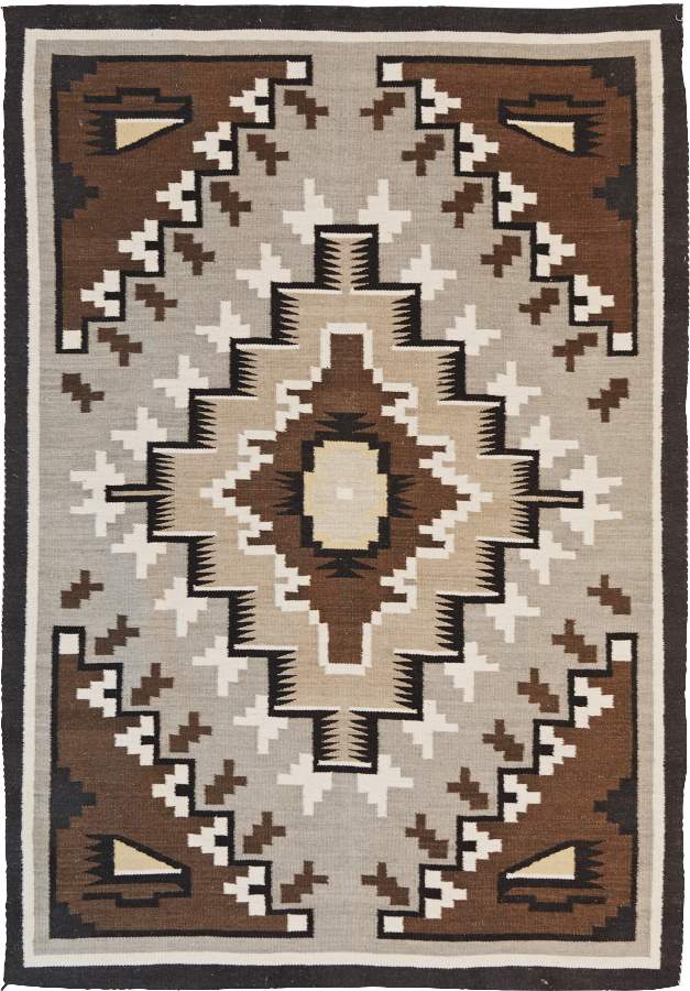 Two Grey Hills Southwest flat-weave wool rug with geometric Navajo-style patterns in brown and grey.