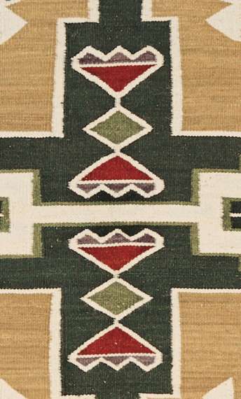 Teec Nos Pos Southwest wool rug with geometric Navajo-inspired patterns in green, tan, and red.