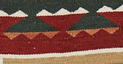 Teec Nos Pos Southwest flat-weave wool rug with red, green, and beige geometric patterns.