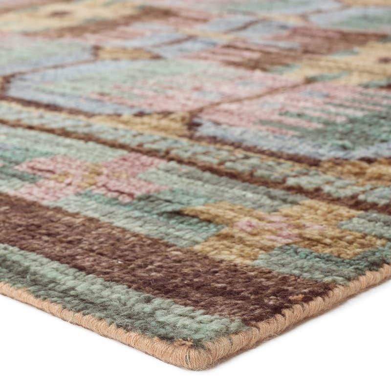 Hazan hand-knotted wool rug with a colorful geometric pattern in green, brown, and pink.