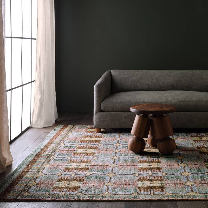 Hazan hand-knotted wool rug with a colorful geometric pattern in a modern living room.