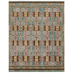 Hazan hand-knotted wool rug featuring a geometric pattern in green, pink, brown, and gold.