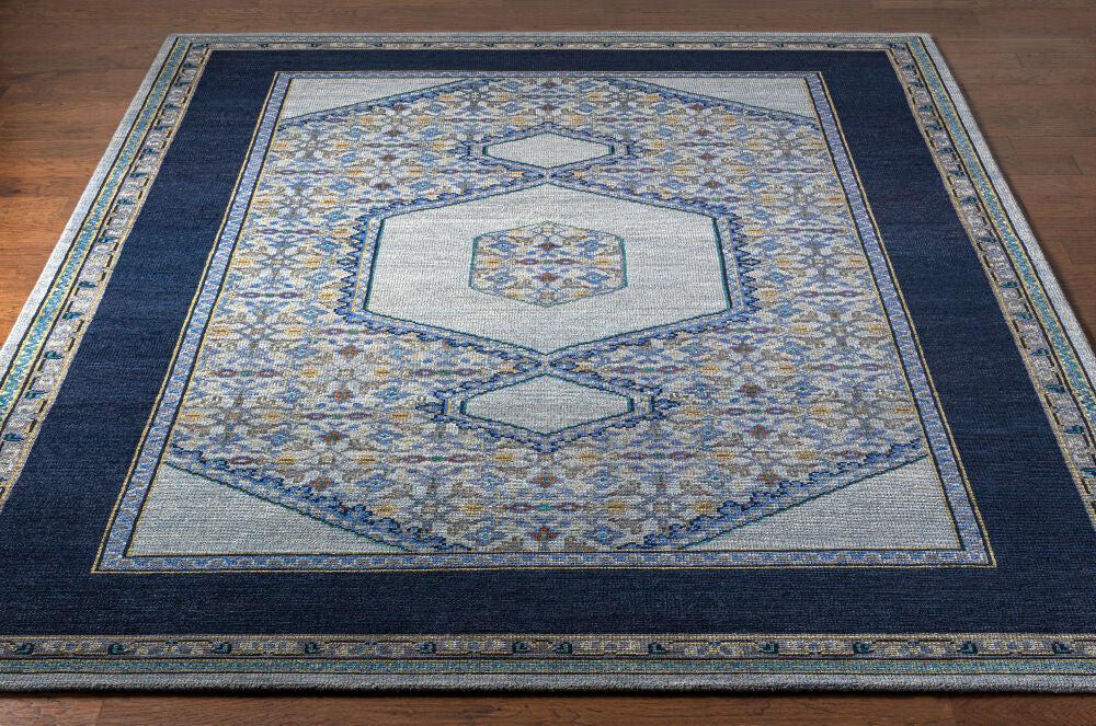 Haven Hand-Knotted wool rug with navy blue border and traditional grey and gold pattern