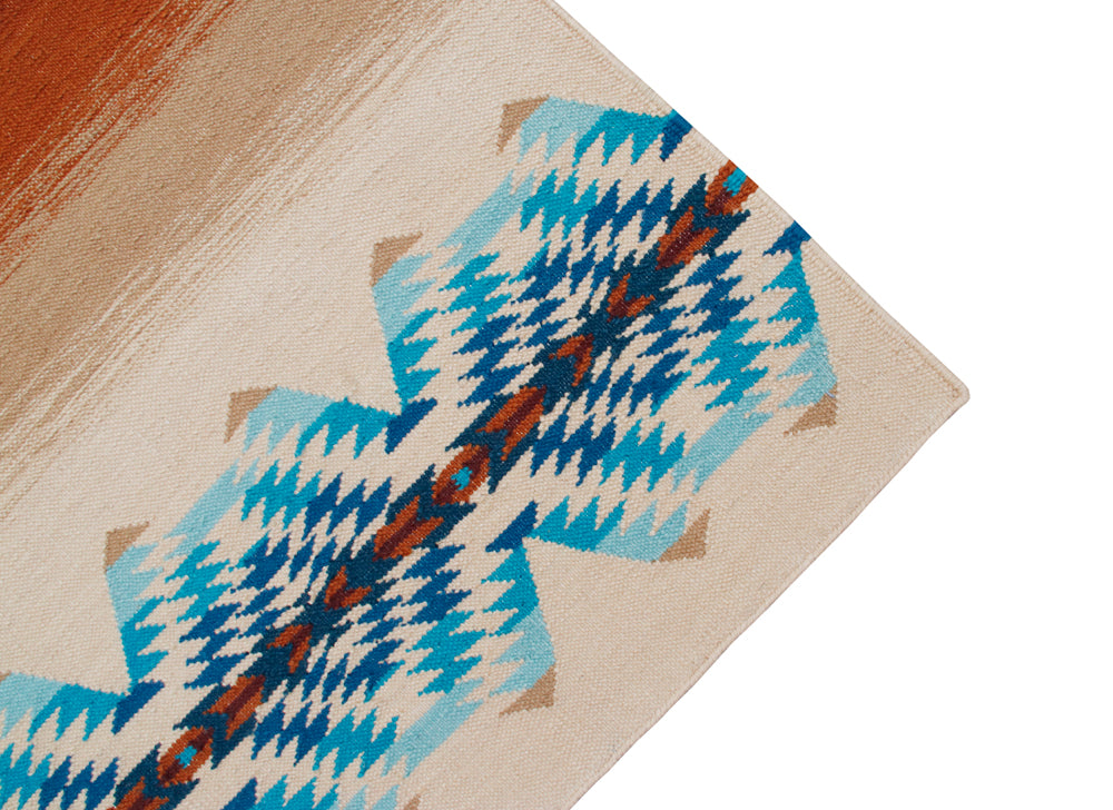 Pendleton Pagosa Springs wool rug corner with blue and orange Southwest geometric patterns