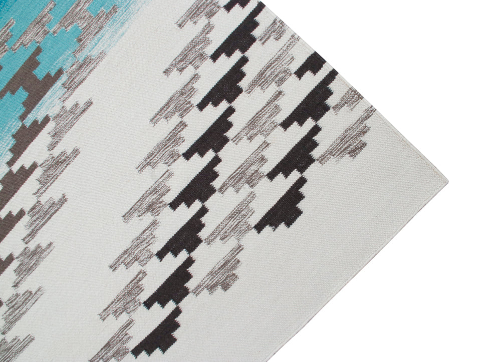 Pendleton Salt Creek turquoise and grey Southwest wool flat-weave rug corner.