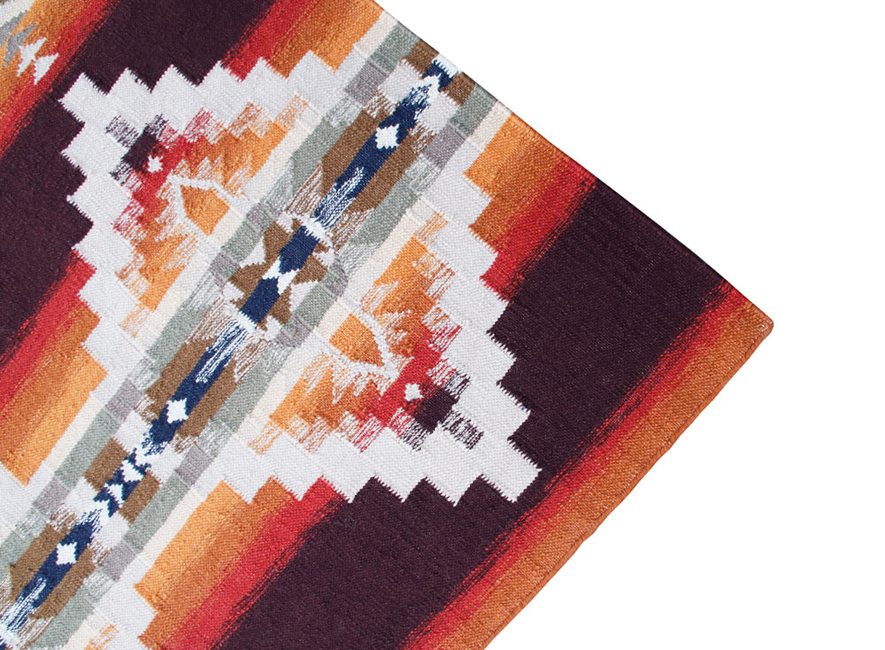 Pendleton Juniper Mesa flat-weave wool rug with Southwest geometric pattern in cinnabar and orange.