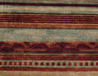 Pendleton Chimayo Southwest hand-knotted wool rug with red, brown, and sage green geometric patterns.
