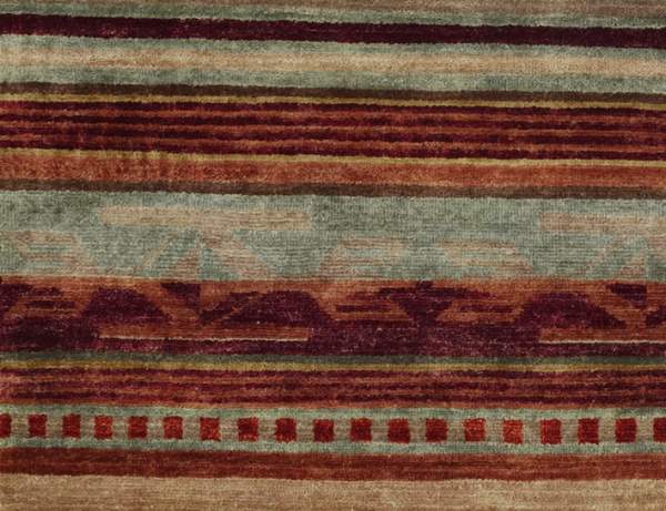 Pendleton Chimayo Southwest hand-knotted wool rug with red, brown, and sage green geometric patterns.