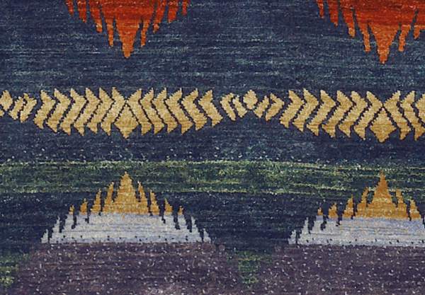 Pendleton Southwest hand-knotted wool rug with blue, gold, and terra cotta geometric patterns.