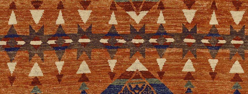 Pendleton TePee Southwest hand-knotted wool rug in burnt orange, brown, and tan with geometric patterns.
