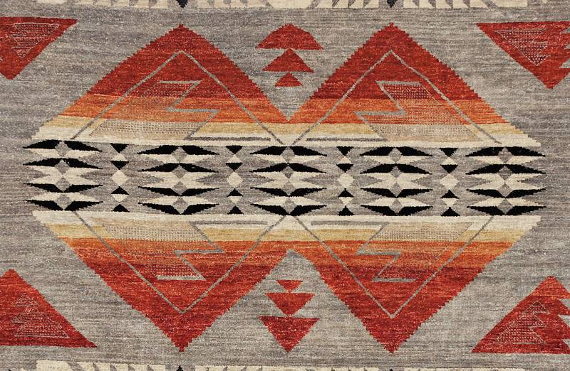 Pendleton Mt. Zion Southwest hand-knotted wool rug with red, black, and white geometric patterns on gray.