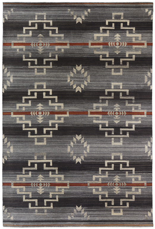 Estancia charcoal Southwest hand-knotted wool rug with geometric patterns and orange accents.
