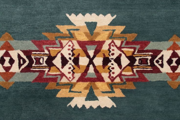 Pendleton teal hand-tufted wool rug with a vibrant Southwest geometric pattern.