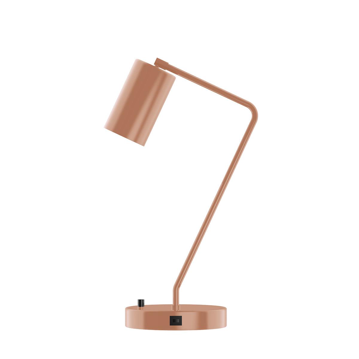 Rose gold cylinder shade desk lamp with a USB port and dimmer switch on the round base.