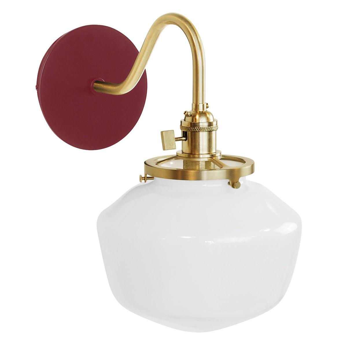 Uno Schoolhouse Gooseneck Sconce with red backplate, brass arm, and white glass shade.