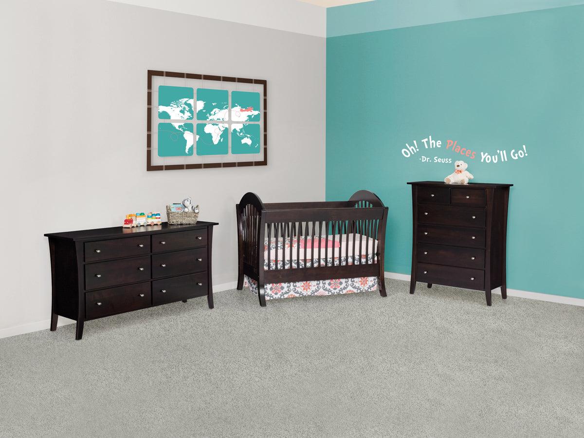 Manhattan dark wood convertible crib set with matching dresser and chest in a nursery