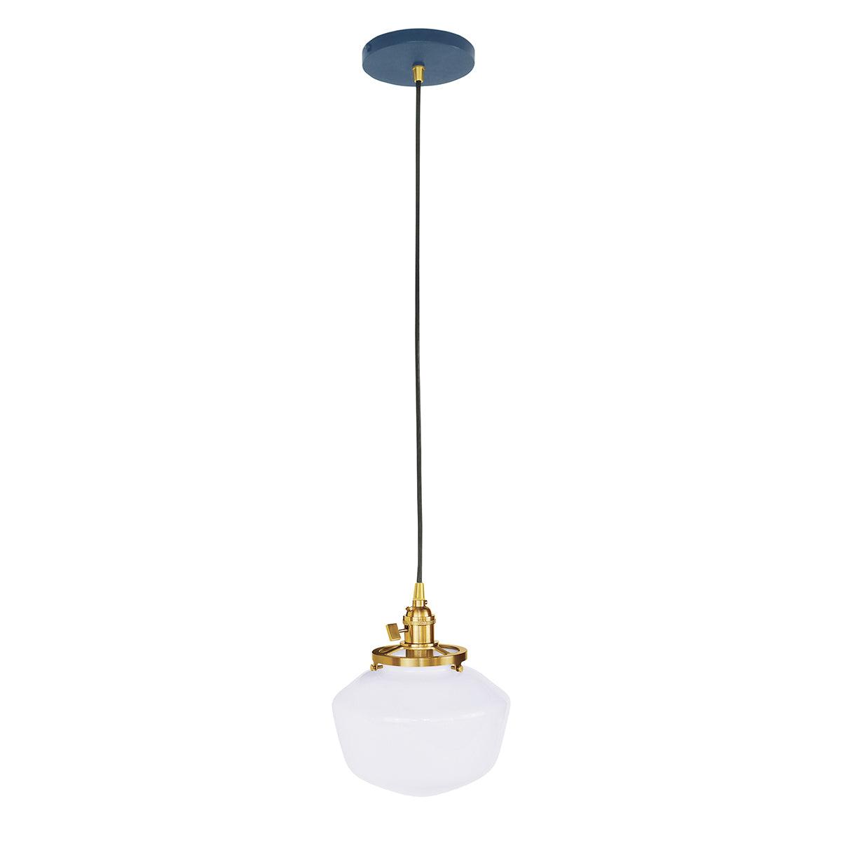 Uno Schoolhouse Pendant with white glass globe, brass hardware, and blue canopy.